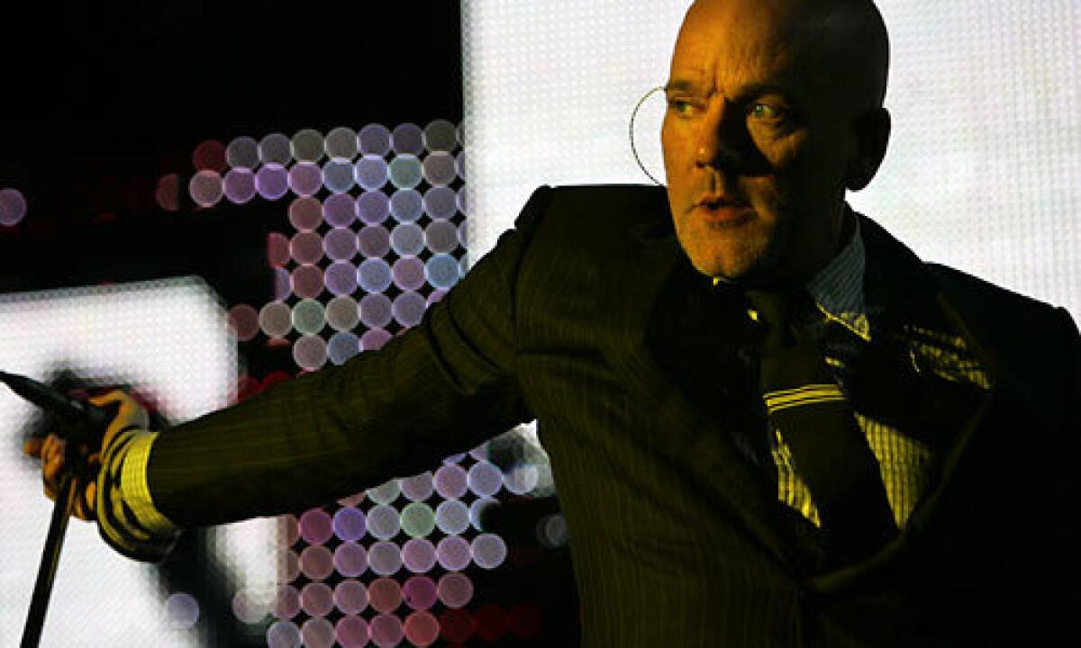 Singer Michael Stipe leads veteran alternative rock band R.E.M. through a concert at the Hollywood Bowl.