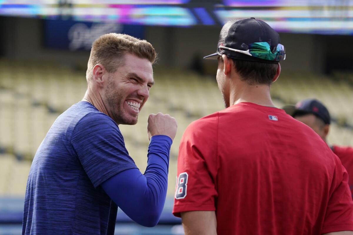 Dodgers first baseman Freddie Freeman talks with Atlanta Braves first baseman Matt Olson.