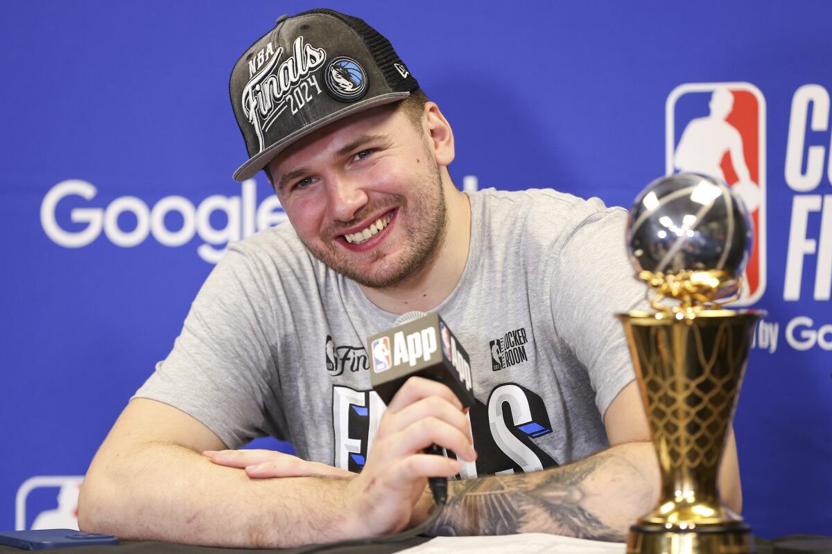 Mavericks guard Luka Doncic smiles big during a news conference after the team's win over the Timberwolves