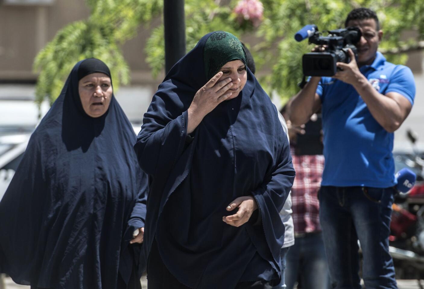 A relative of a passenger who was flying aboard an EgyptAir plane that crashed en route from Paris to Cairo cries as family members are transported to a gathering point at Cairo International Airport on May 19.