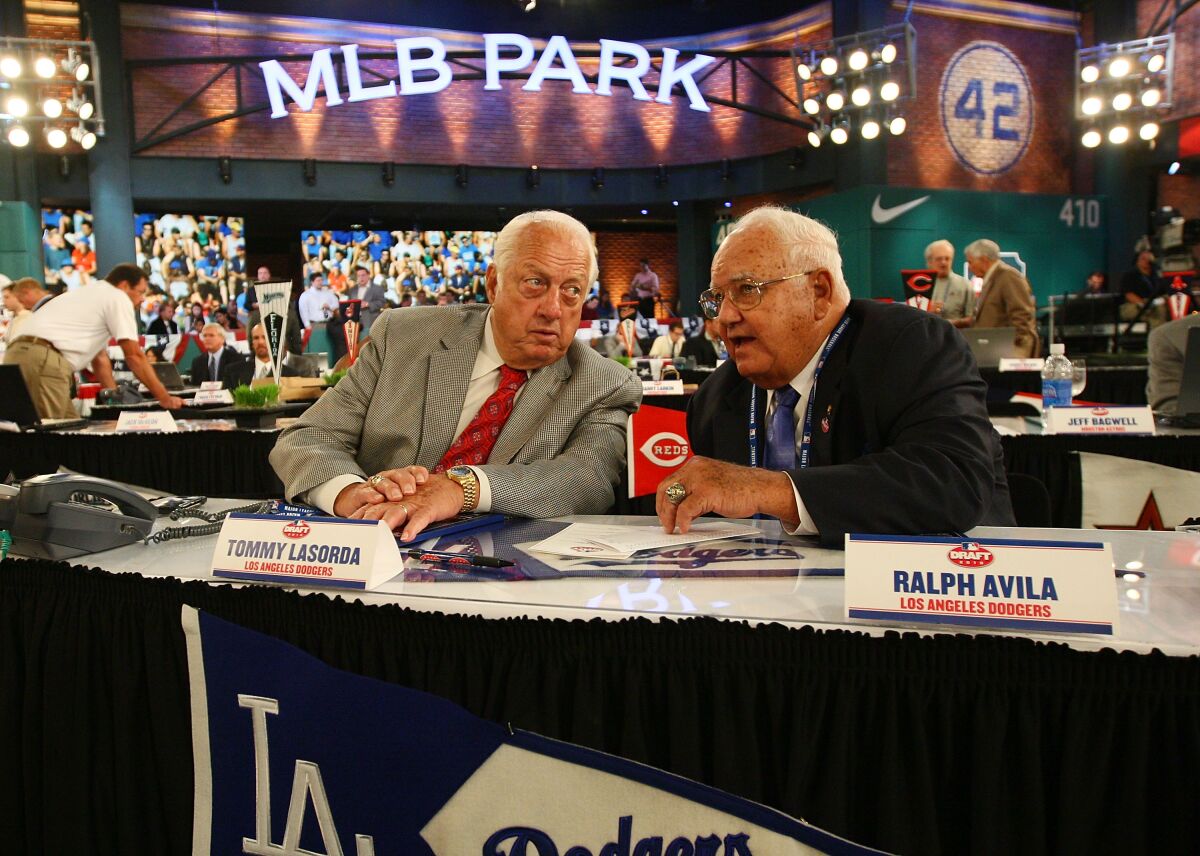Ralph Avila, right, and Tommy Lasorda speak while representing the Dodgers at the 2010 MLB draft.
