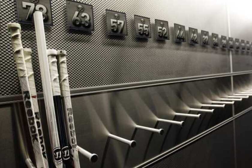 A nearly empty hockey stick rack in the Buffalo Sabres locker room.
