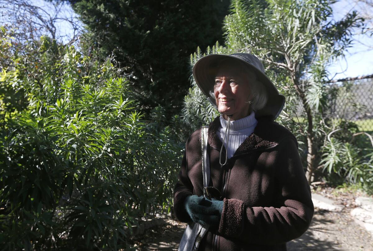 Secret Garden manager Juana Mueller walks through the Secret Garden at Huntington Central Park.