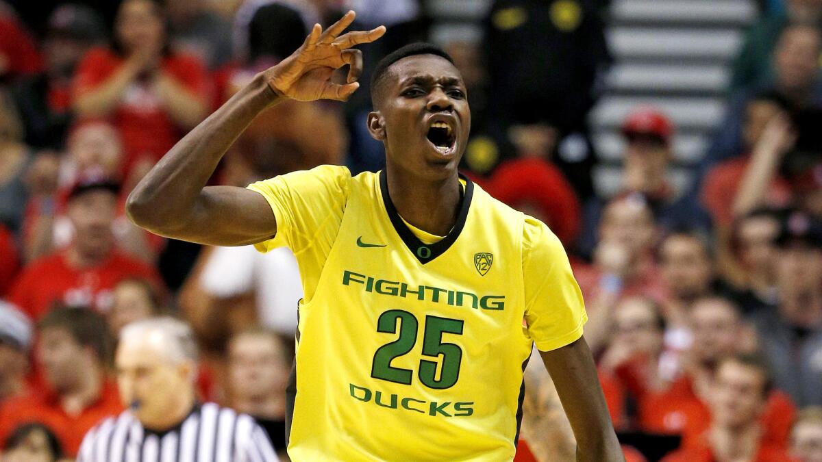 Oregon forward Chris Boucher reacts after making a three-point shot against Utah during the first half Saturday.