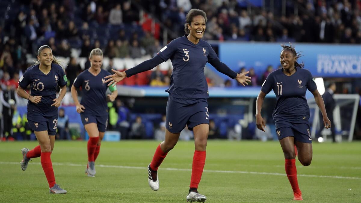 France's Wendie Renard, middle, celebrates with teammates after scoring her second goal during a Women's World Cup Group A against South Korea on Friday in Paris.