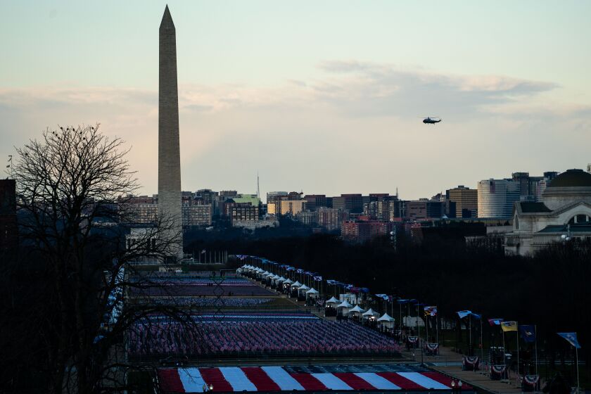 WASHINGTON, DC - JANUARY 20: Marine One flies by the Washington Monument as President Donald Trump departs Washington DC on the morning of the 59th Presidential Inauguration ceremonies on the West Front of the U.S. Capitol Building on Wednesday, Jan. 20, 2021 in Washington, DC. Joe Biden will be sworn in as the 46th President of the United States. (Kent Nishimura / Los Angeles Times)