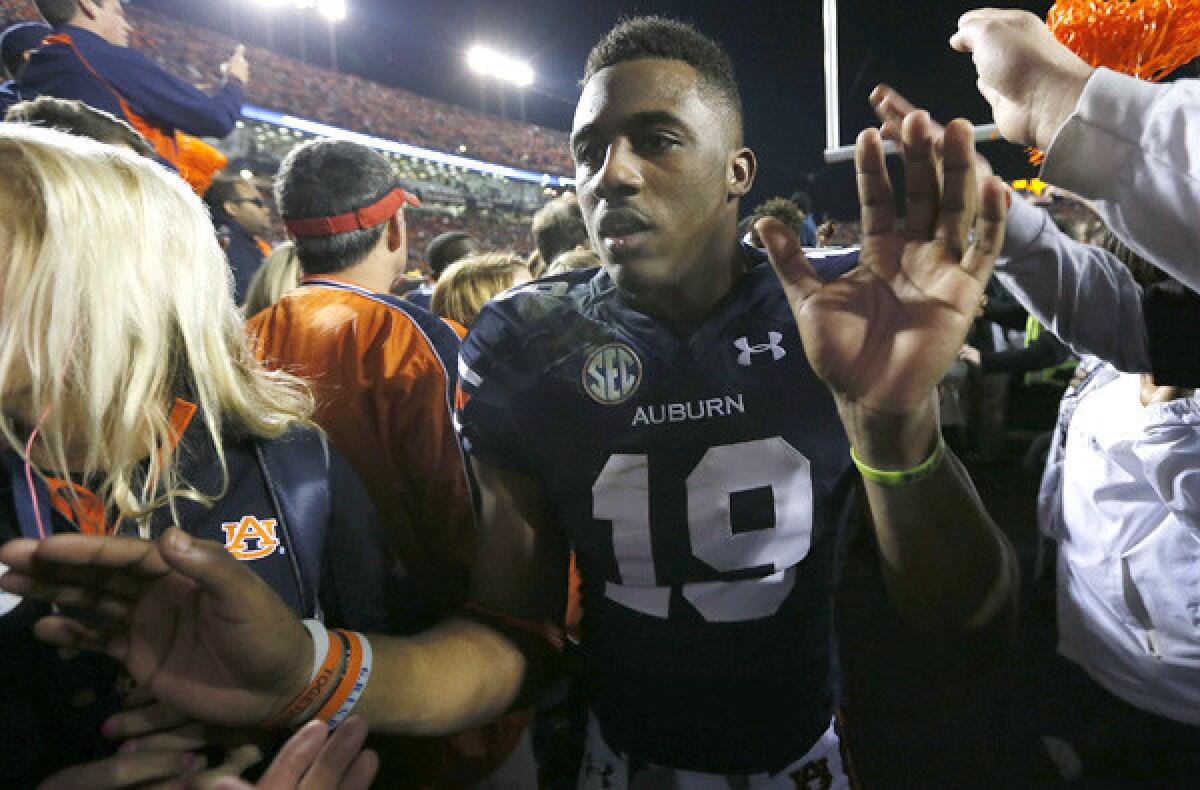 Auburn defensive back Ryan White celebrates with fans after defeating Alabama in the Iron Bowl.
