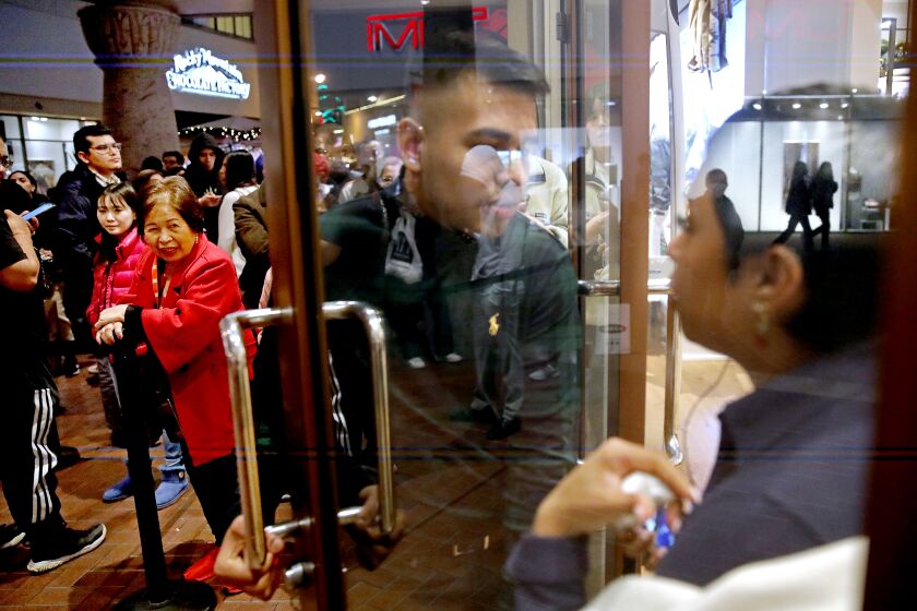 COMMERCE, CA - NOVEMBER 24: Shoppers waiting to get into the Polo Ralph Lauren Factory Store to enjoy exclusive Black Friday deals on Thanksgiving night through the holiday weekend at the Citadel Outlets on Thursday, Nov. 24, 2022 in Commerce, CA. Citadel Outlets will open its doors to shoppers beginning at 8:00 p.m. on Thanksgiving for an all-night shopping party! Select stores will open their doors as early as noon, while most stores will open at 8:00 p.m. on Thanksgiving through 11:00 p.m. on Black Friday, staying open for over 27 hours straight. All stores will welcome shoppers at 6:00 a.m. on Black Friday and extended hours will continue through the weekend. (Gary Coronado / Los Angeles Times)