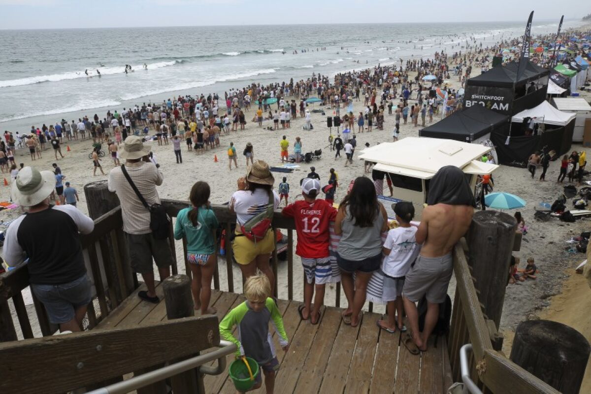 A large crowd watches the surf joust contest during the Switchfoot Bro-Am music and surf festival.