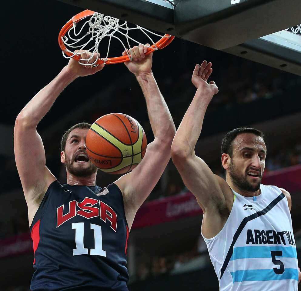 Kevin Love of the United States slams home two points over Argentine defender Manu Ginobili in the first half of the London Olympics men's basketball semifinal game.