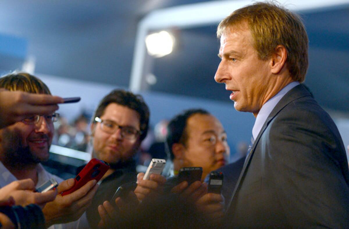 U.S. Coach Juergen Klinsmann talks to reporters on Friday after the final draw for the preliminary round groups of the 2014 World Cup.