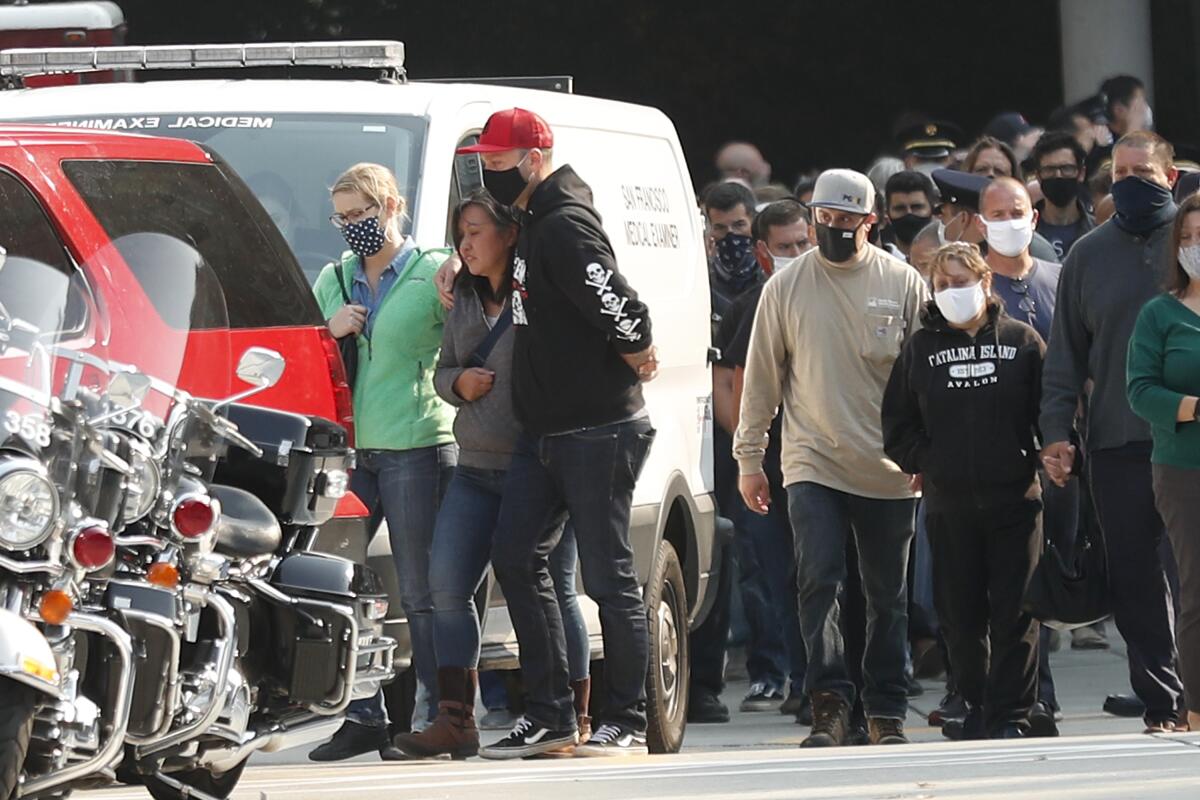 Family and friends of deceased firefighter Jason Cortez head to Fire Department vehicles for a procession.