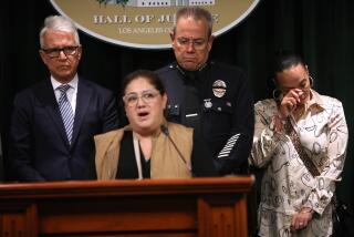 LOS ANGELES, CA - NOVEMBER 9, 2023 - Los Angeles County District Attorney George Gascon, from left, background, Los Angeles Police Chief Michel Moore and Eddrinna Cunningham, mother of LA Police Officer Darrell Cunningham listens as Gloria Cea, godmother to Jorge Soriano, address the media on the car crash that took their lives at the Hall of Justice in downtown Los Angeles on November 9, 2023. Olivarez is being charged with two counts of murder, two felony counts of gross vehicular manslaughter while intoxicated and one felony count of driving under the influence of alcohol and a drug causing the deaths of Officer Cunningham and Soriano. (Genaro Molina / Los Angeles Times)