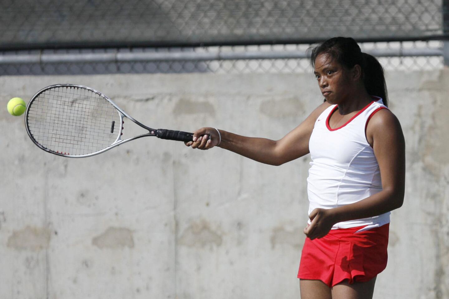 Burroughs' Jomelle Eligio hits the ball during a match against Hoover at Hoover High School in Glendale on Tuesday, September 11, 2012.