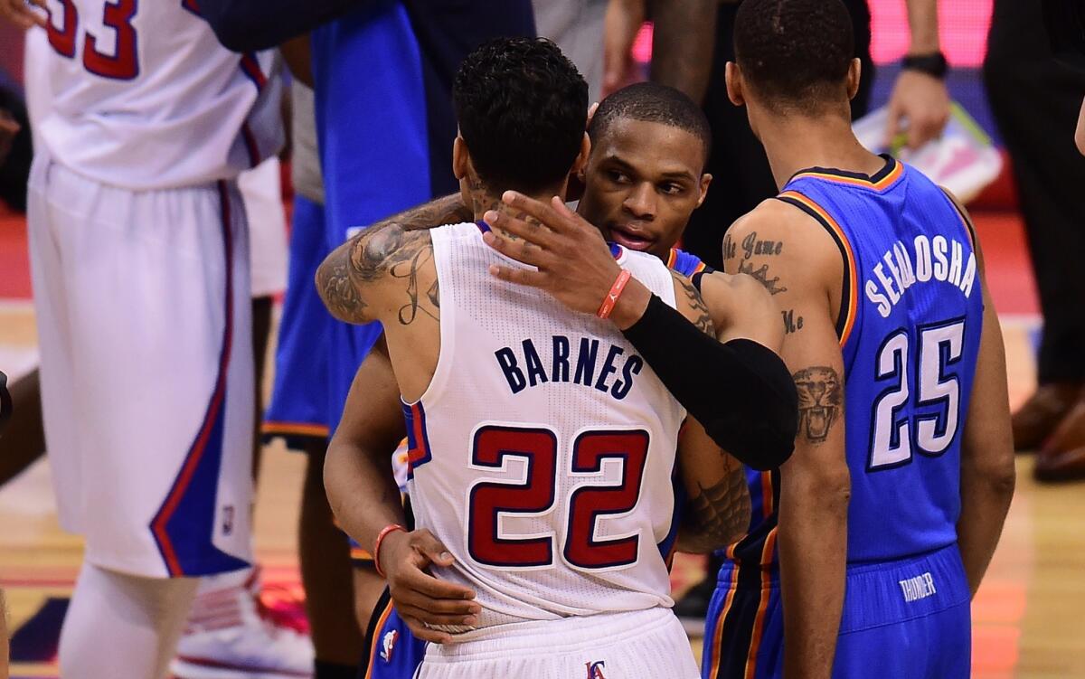 Oklahoma City Thunder guard Russell Westbrook and Clippers forward Matt Barnes exchange a hug on May 15. The Clippers could package Barnes with their first-round pick in a draft-day deal.