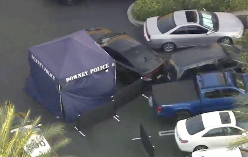 A Downey police tent set up next to a car that had collided with another car in a car park