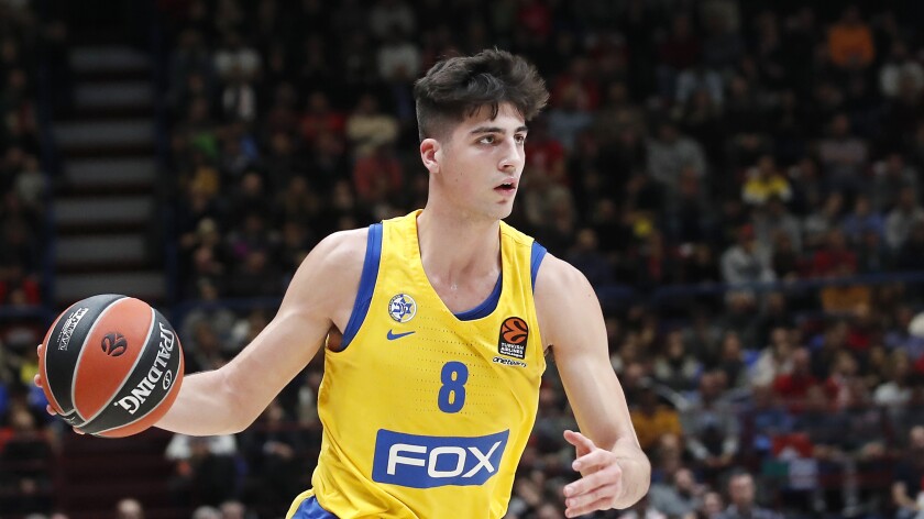 Deni Avdija brings the ball up court for Maccabi Fox Tel Aviv in a Euroleague game against Olimpia Milan on Nov. 19, 2019.