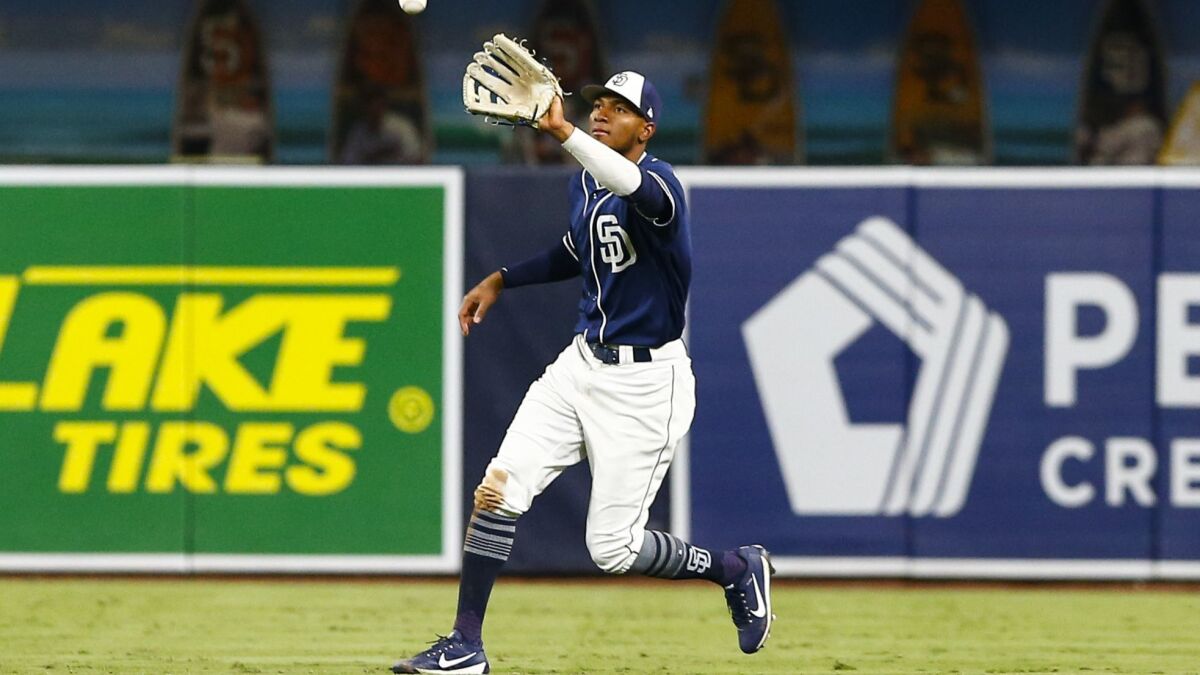 Padres right fielder Edward Olivares (82) catches a fly ball from Rangers third baseman Diosbel Arias (73) in the fifth inning in a minor league exhibition game at Petco Park on Sept. 27, 2018.
