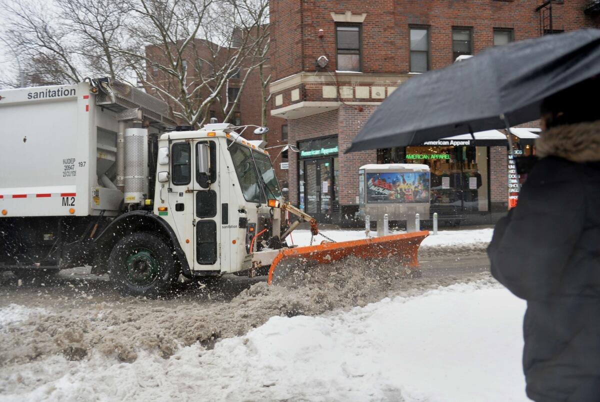 A sanitation truck plows Bleecker Street in the Greenwich Village area of Manhattan February 13, 2014 in New York. Up to a foot (30 cm) of snow is expected in the New York area. As the storm moved north, the US National Weather Service warned that the "mammoth dome" of Arctic air would cut a wide swath of winter weather from Georgia to New England. The latest brutal freeze to hammer the eastern states of the country since the start of the year has been dubbed "snowmaggedon," "mind-boggling" and "historic" by major television networks and forecasters. AFP PHOTO/Stan HONDASTAN HONDA/AFP/Getty Images ** OUTS - ELSENT, FPG, TCN - OUTS * NM, PH, VA if sourced by CT, LA or MoD **
