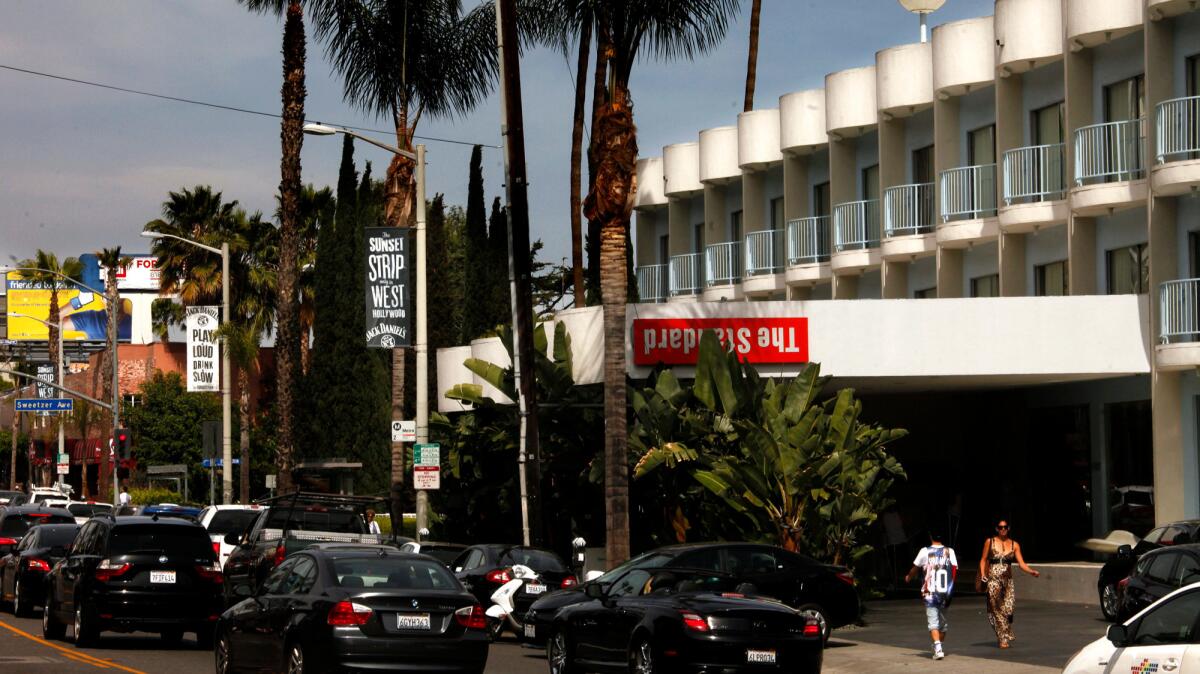 Pedestrians and traffic pass in front of the Standard Hotel on Sunset Boulevard in West Hollywood.
