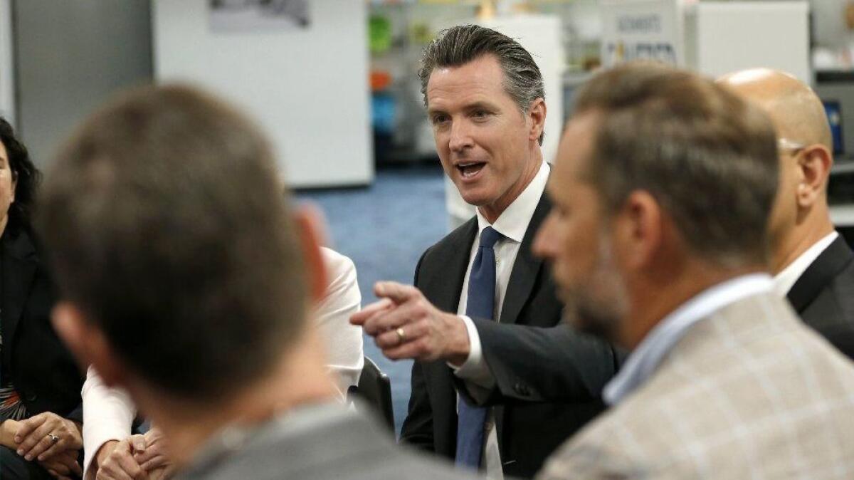 Gov. Gavin Newsom discusses his healthcare proposals at a round-table discussion with small-business owners on Tuesday in Sacramento.