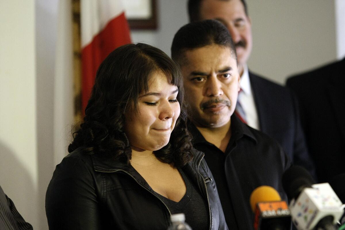 Gabriela Sanchez and Juan Arevalo, daughter and brother of slain store clerk Martha Sanchez, speak at a news conference to announce the filing of murder charges.