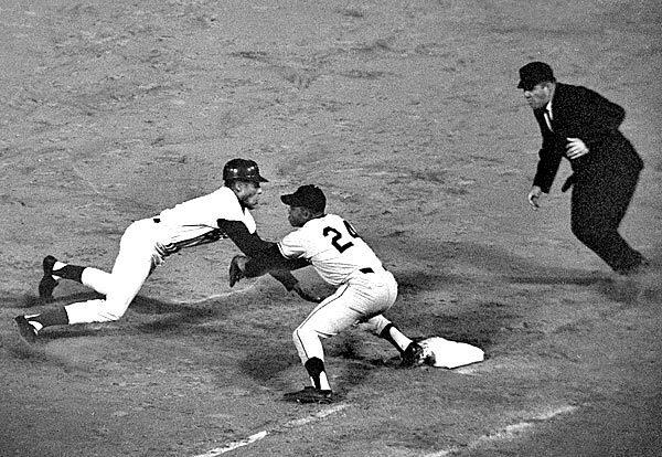 Davis, left, seen in 1964, is tagged out on a third-inning pick-off play by San Francisco Giants center fielder Willie Mays while playing first base for the first time in his major league career.