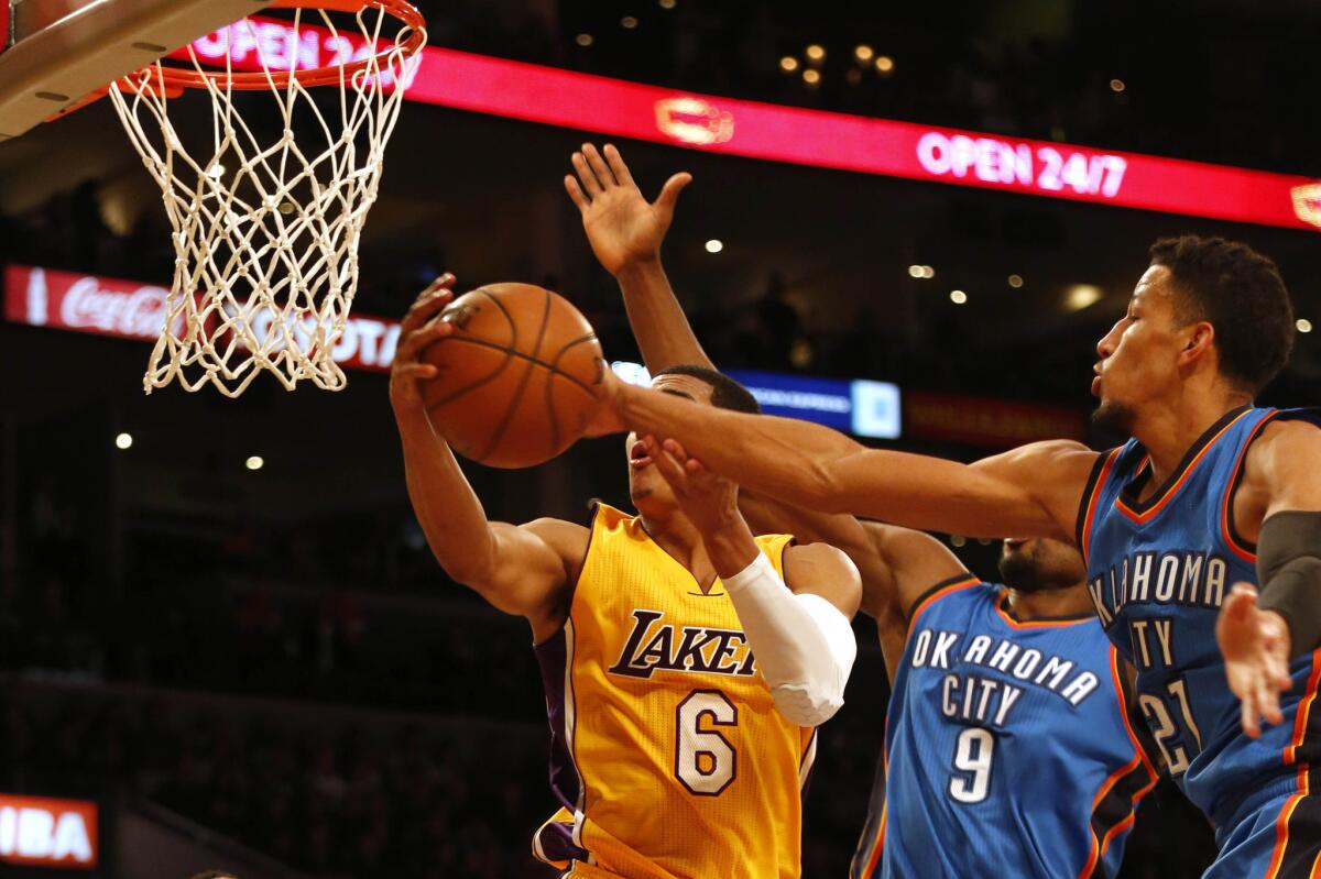 Lakers guard Jordan Clarkson attempts to navigate a trio of Thunder defenders for a layup Wednesday night.