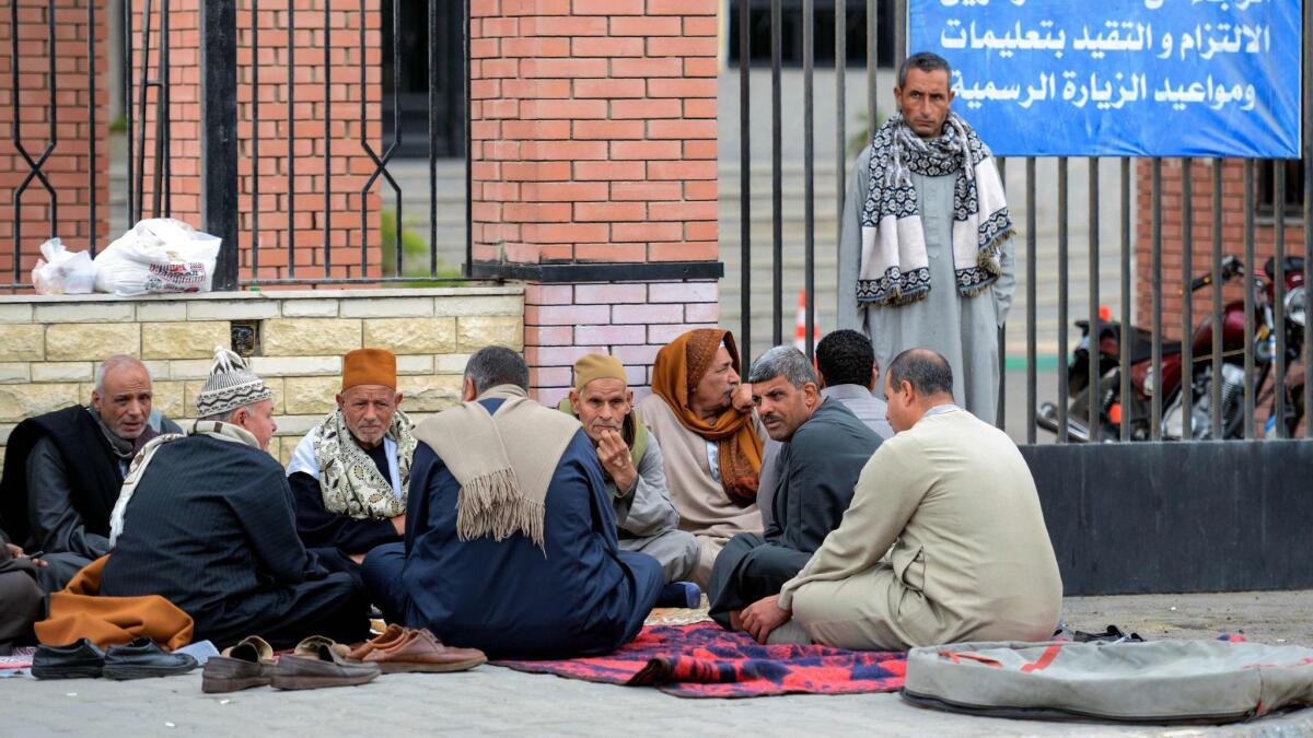 Relatives of the victims of the bomb and gun assault on the North Sinai Rawda mosque wait Nov. 25 outside the hospital in the eastern port city of Ismailia.