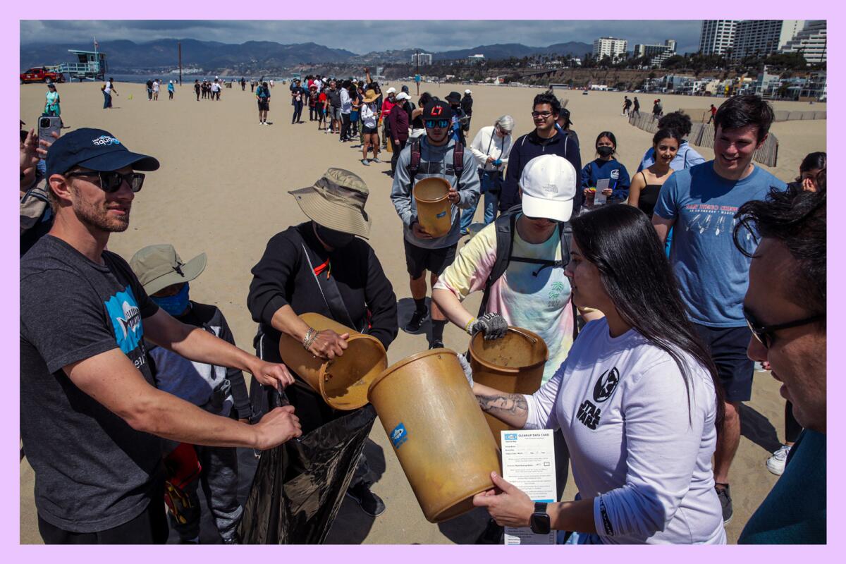 Cleanup volunteers line up to dump trash collected in Santa Monica