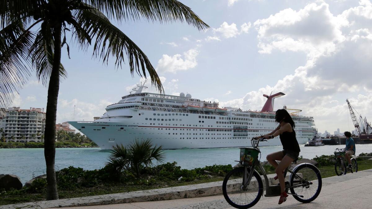 Some cruise lines are making plans to return to islands hard hit by hurricanes. The Carnival Ecstasy, shown here in Miami, is expected to call on Grand Turk on Nov. 1.