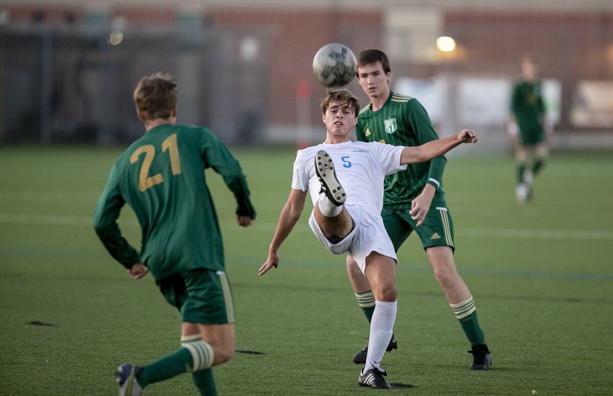 Corona del Mar's Luke Ianni handles a ball during a Surf League boys' soccer match against Edison on Wednesday.