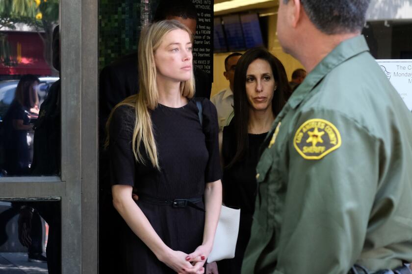 Actress Amber Heard leaves Los Angeles Superior Court court on May 27 after giving a sworn declaration that her husband Johnny Depp threw her cellphone at her during a fight, striking her cheek and eye.