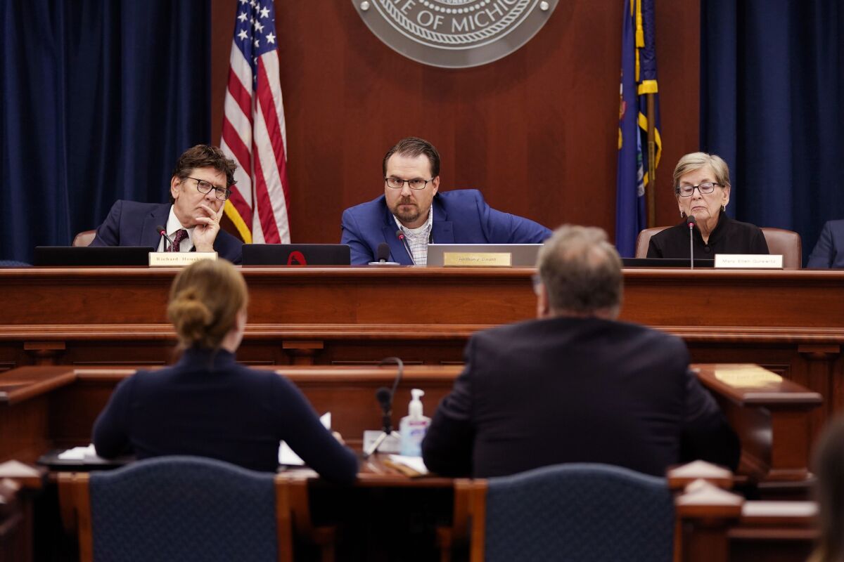 FILE - Members of the Michigan Board of State Canvassers, from left, Richard Houskamp, Anthony Daunt and Mary Ellen Gurewitz listen to attorneys Olivia Flower and Steve Liedel during a hearing, Wednesday, Aug. 31, 2022, in Lansing, Mich. Republican-dominated courts and legislatures have been pushing back against citizen-led ballot initiatives to keep them off the ballot, in what critics say is a partisan attack on direct democracy. (AP Photo/Carlos Osorio, File)