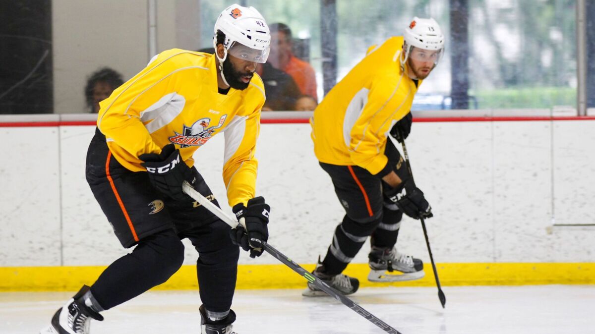 Jordan Samuels-Thomas, left, and Scott Sabourin of the Gulls do a drill during a team practice Wednesday at the Poway Ice Center.