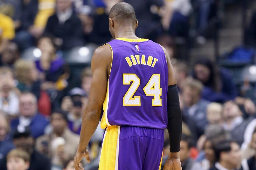 Lakers star Kobe Bryant walks off the court during a 110-91 loss to the Indiana Pacers on Monday.