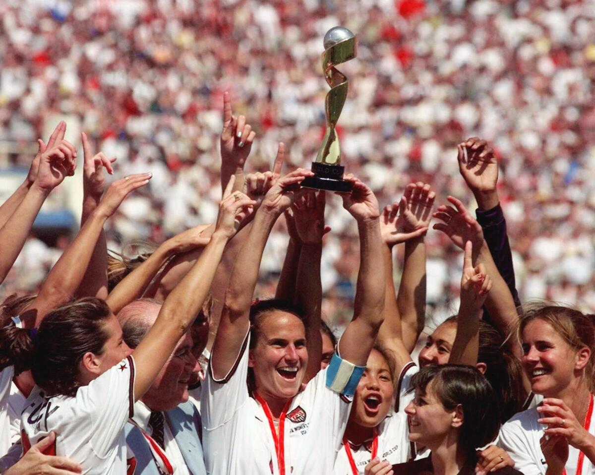 U.S. women's soccer team captain Carla Overbeck, center, celebrates with her teammates after winning the 1999 World Cup.