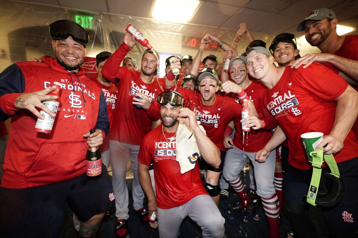 Members of the St. Louis Cardinals celebrate after defeating the Milwaukee Brewers in a baseball game to win the National League Central title Tuesday, Sept. 27, 2022, in Milwaukee. (AP Photo/Morry Gash)