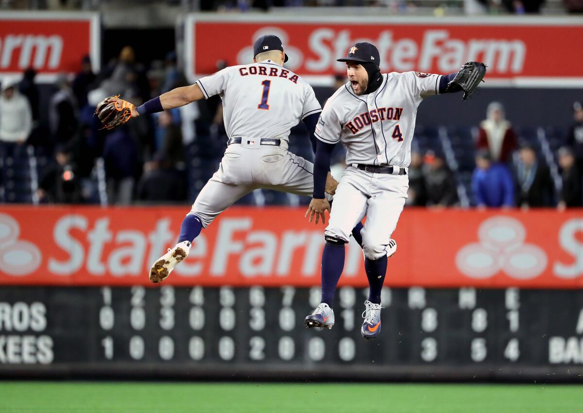 NEW YORK, NEW YORK - OCTOBER 17: Carlos Correa #1 and George Springer #4 of the Houston Astros celebrate their teams 8-3 win over the New York Yankees in game four of the American League Championship Series at Yankee Stadium on October 17, 2019 in New York City. (Photo by Elsa/Getty Images) *** BESTPIX *** ** OUTS - ELSENT, FPG, CM - OUTS * NM, PH, VA if sourced by CT, LA or MoD **