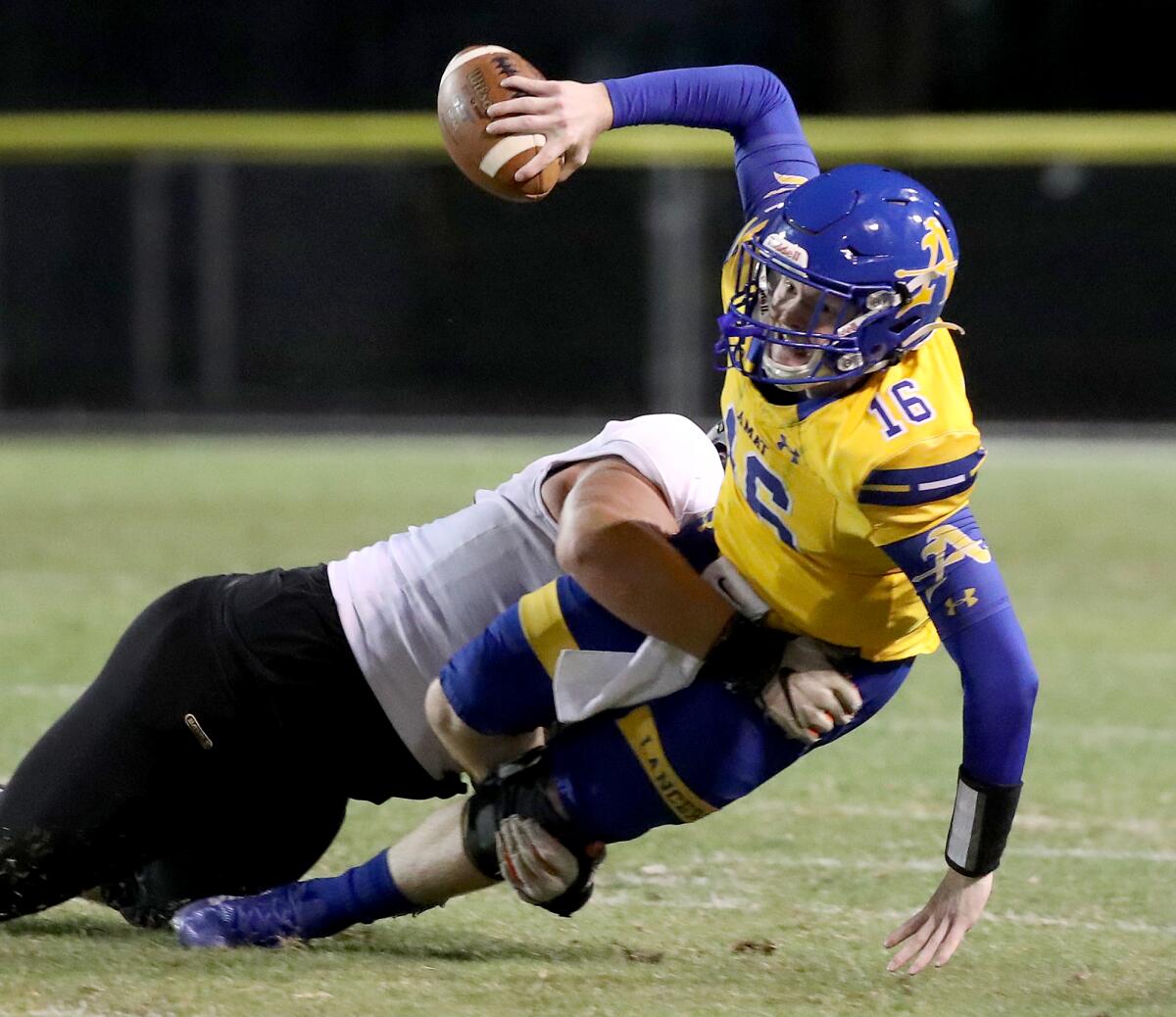 Bishop Amat quarterback Tobin O'Dell is sacked by Servite defensive tackle Mason Graham.