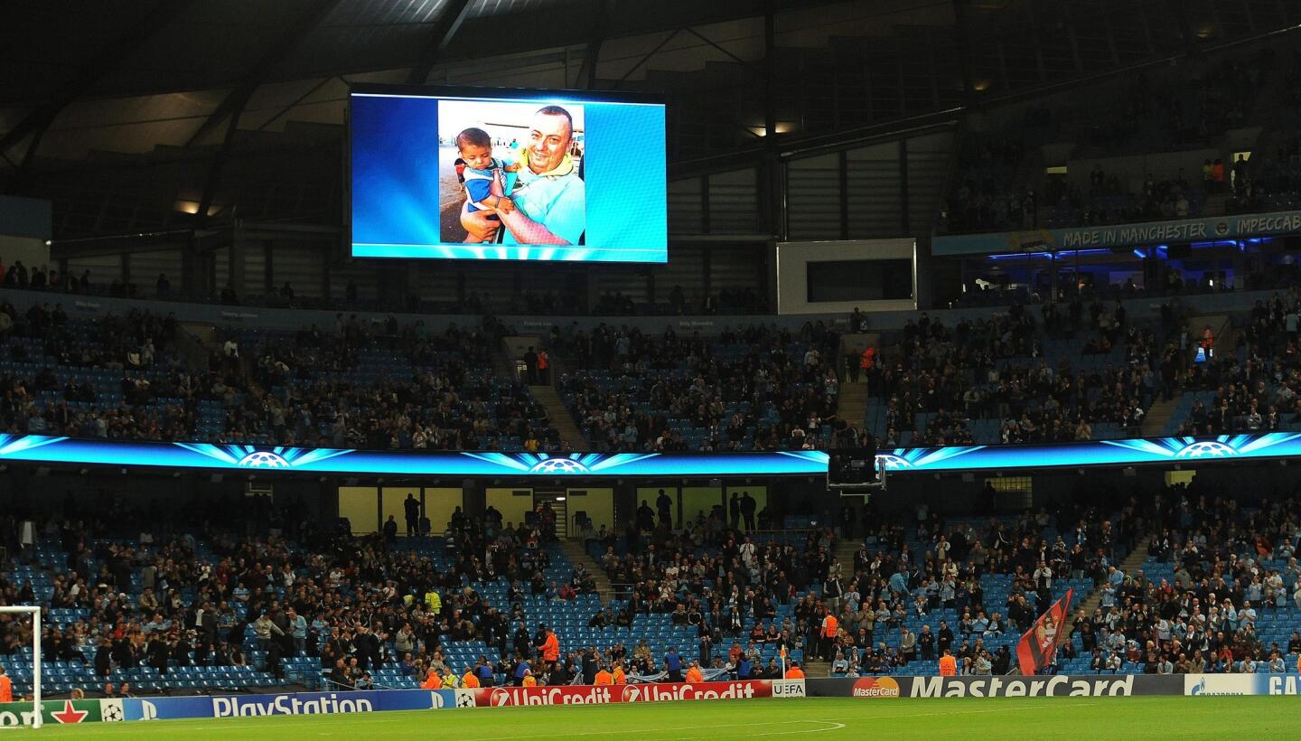 A photo of the hostage Alan Henning, is projected on a huge screen before the UEFA Champions League group E soccer match between Manchester City and AS Roma in Manchester, Britain.