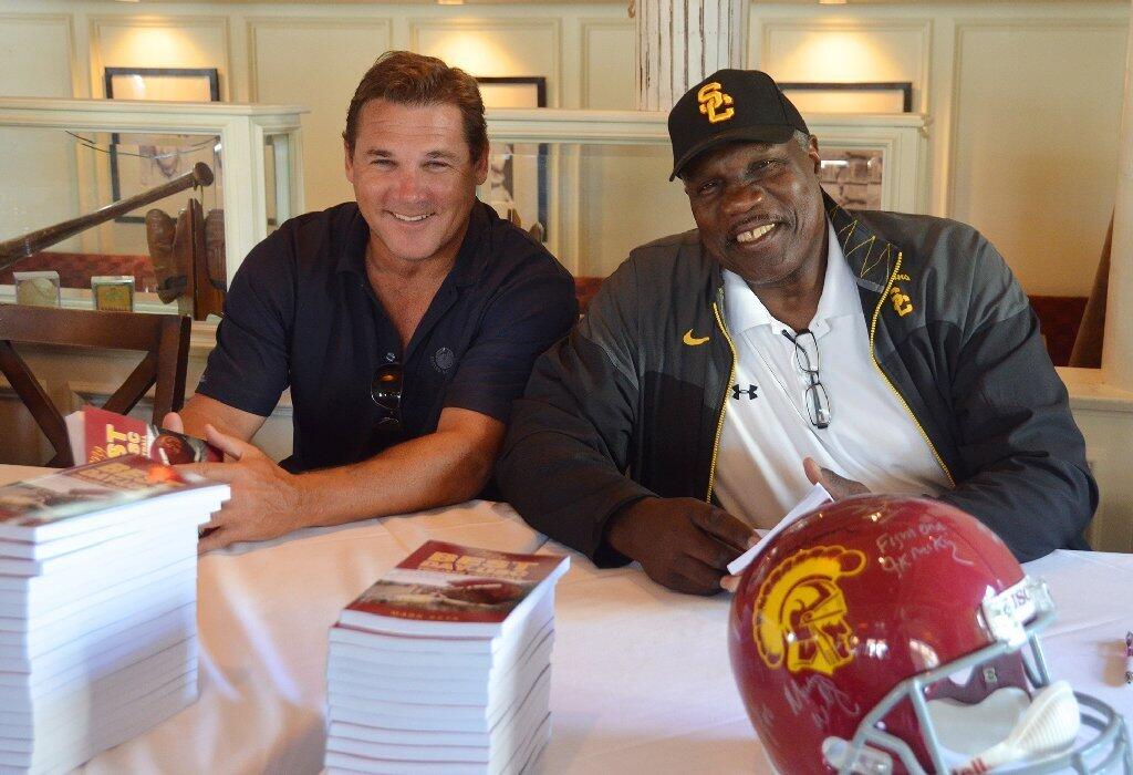 Former USC football players Mike Salmon, left and Charle Young joined in the signing of the My Best Day books held Saturday at The Cannery Restaurant.