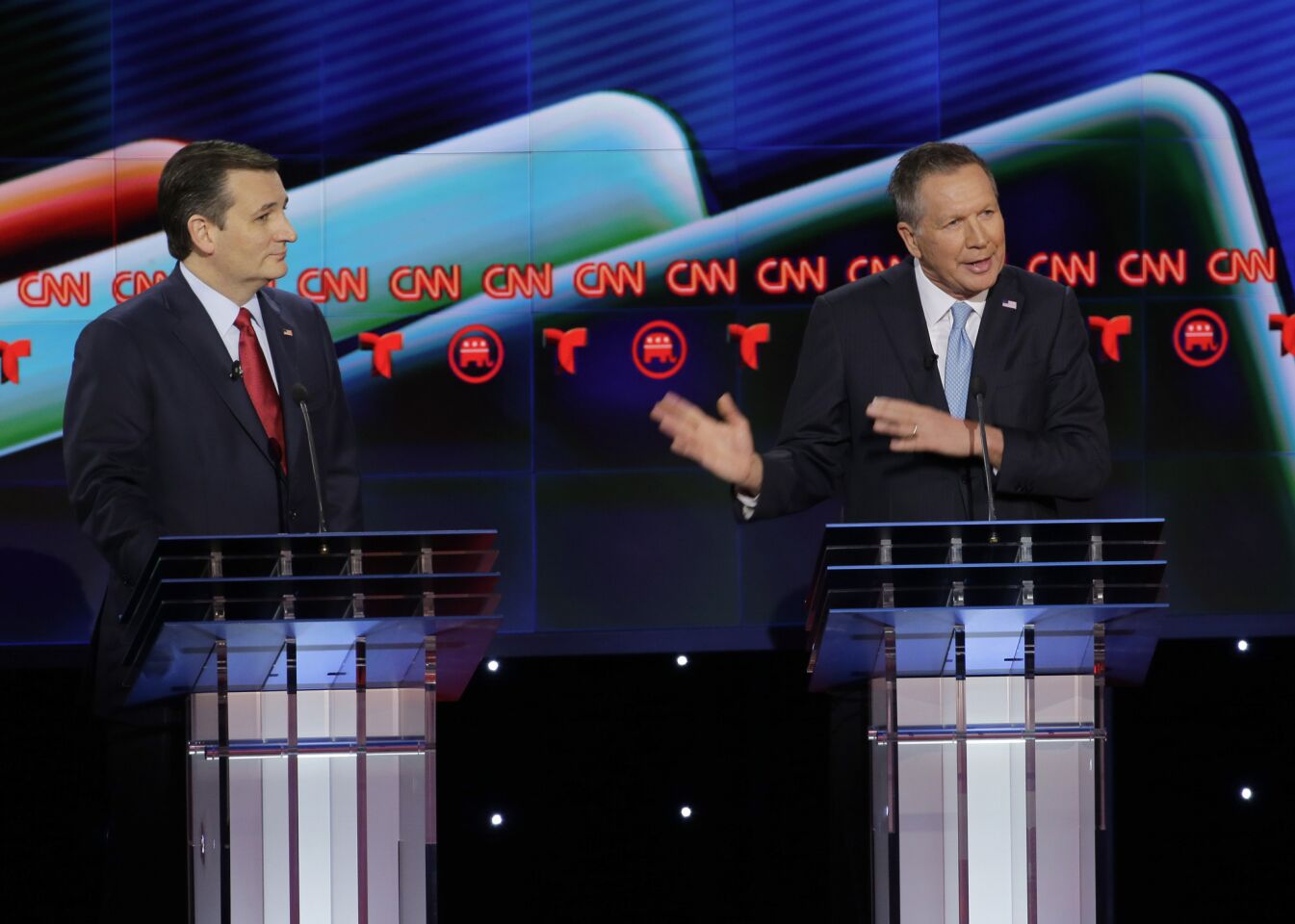 GOP candidate John Kasich, right, speaks as rival Ted Cruz looks on.