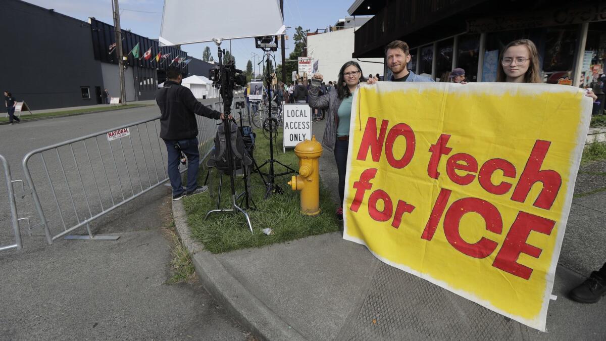 People asking Amazon.com to not sell face-recognition and other technology to federal agencies demonstrate outside the company's annual shareholders meeting Wednesday in Seattle.