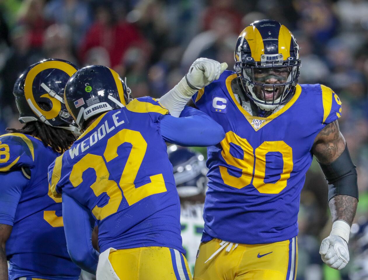 Rams free safety Eric Weddle and defensive end Michael Brockers celebrate after stopping a Seahawks drive.