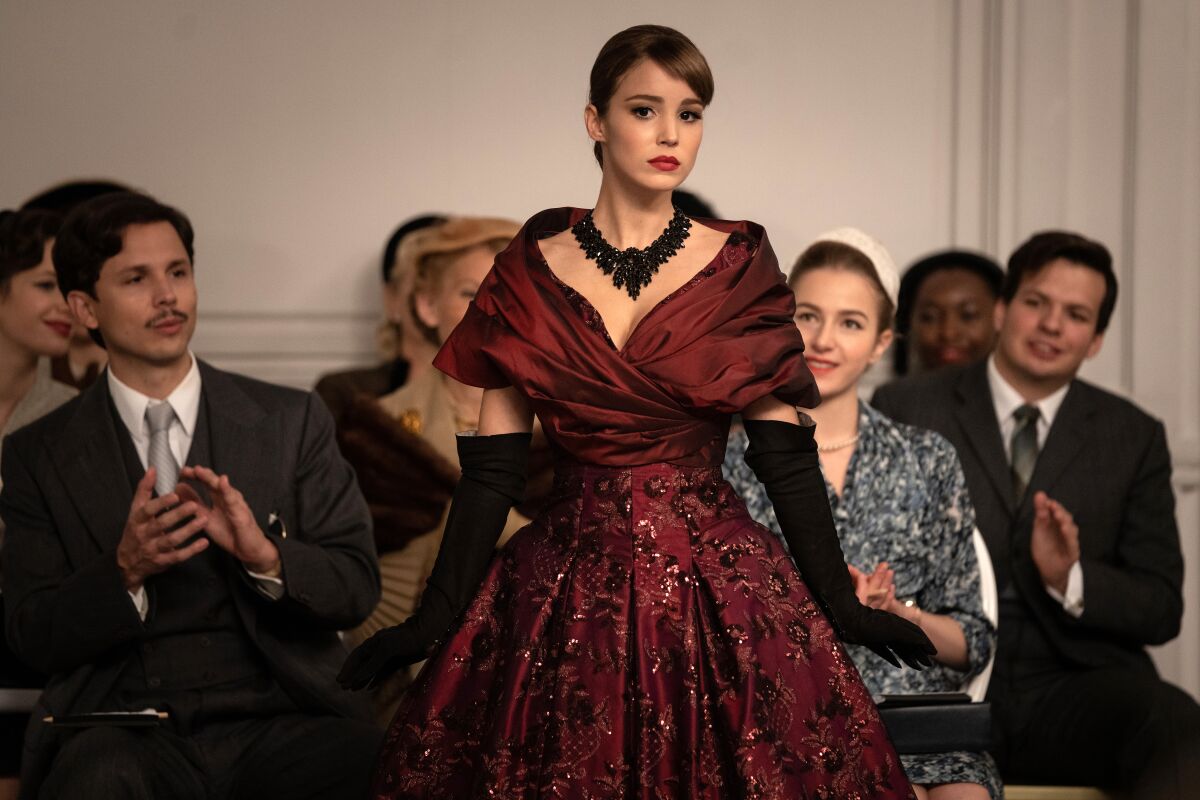 A fashion model shows off a deep claret-colored gown in "Mrs. Harris Goes to Paris."