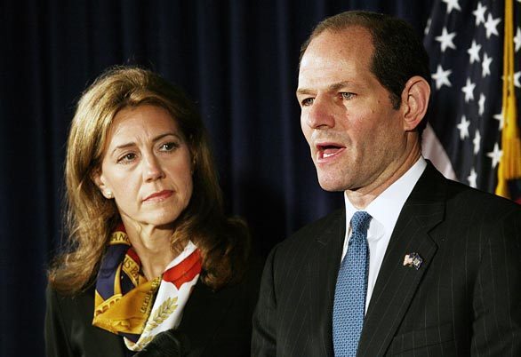 New York Gov. Eliot Spitzer, implicated as a customer of a prostitution ring, announces his resignation. At his side is his wife, Silda.