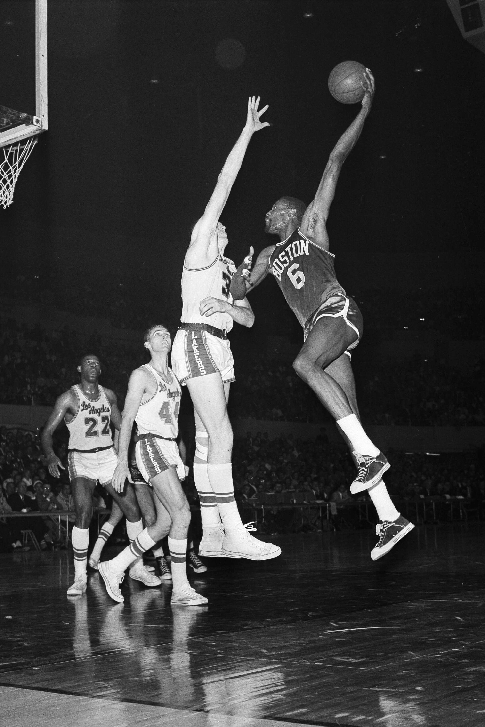 Celtics center Bill Russell attempts a hook shot over Lakers center Jim Krebs.