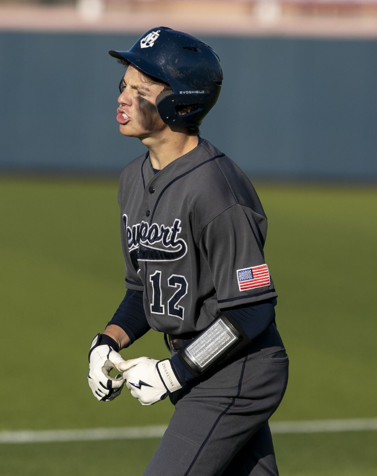 Newport Harbor's Nick Montgomery celebrates after beating out an infield single for a run batted in on Friday.