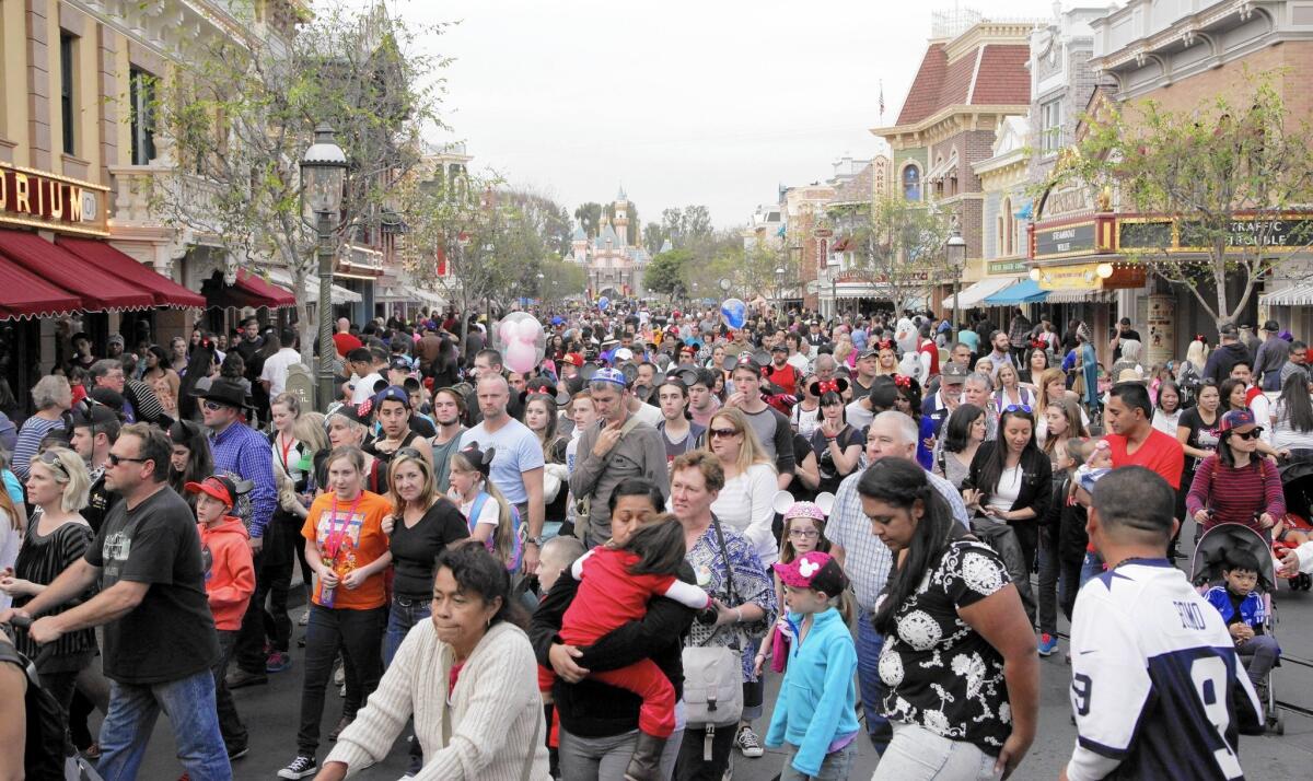 Visitors crowd into Disneyland's Main Street in January. The Anaheim theme park is preparing for even bigger crowds during its 60th anniversary celebration this summer.